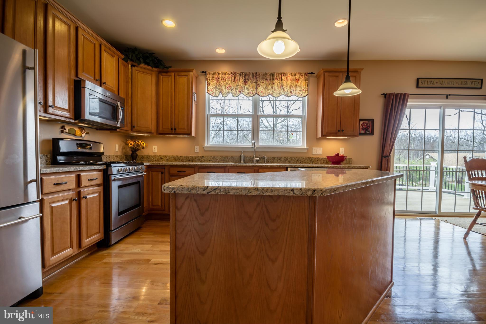 171 Wright Road Winchester, VA 22603 - Photo 4 of 30 a kitchen with stainless steel appliances granite countertop a sink a stove a refrigerator cabinets and a window