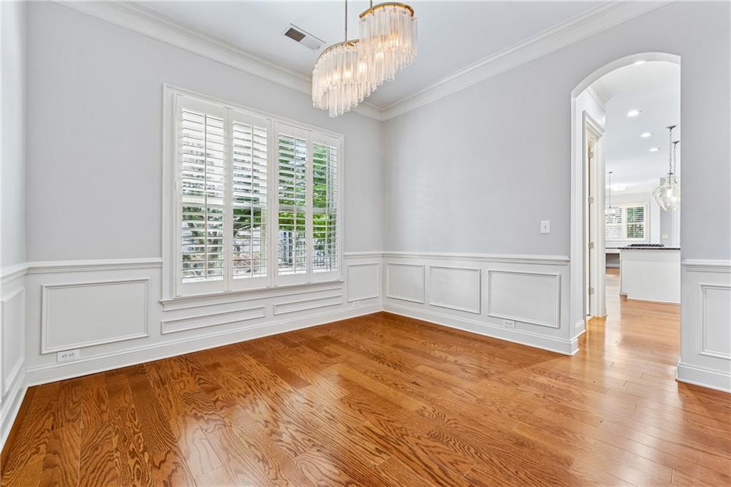 4865 Chase Lane Cumming, GA 30040 - Photo 11 of 70 a view of an empty room with a window and wooden floor