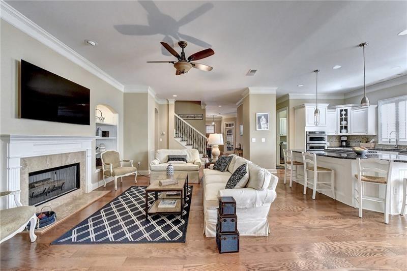 4865 Chase Lane Cumming, GA 30040 - Photo 22 of 70 a living room with furniture a fireplace and a flat screen tv