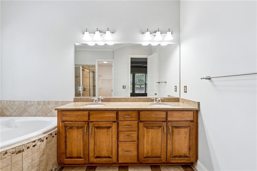4865 Chase Lane Cumming, GA 30040 - Photo 33 of 70 a bathroom with a sink and a mirror