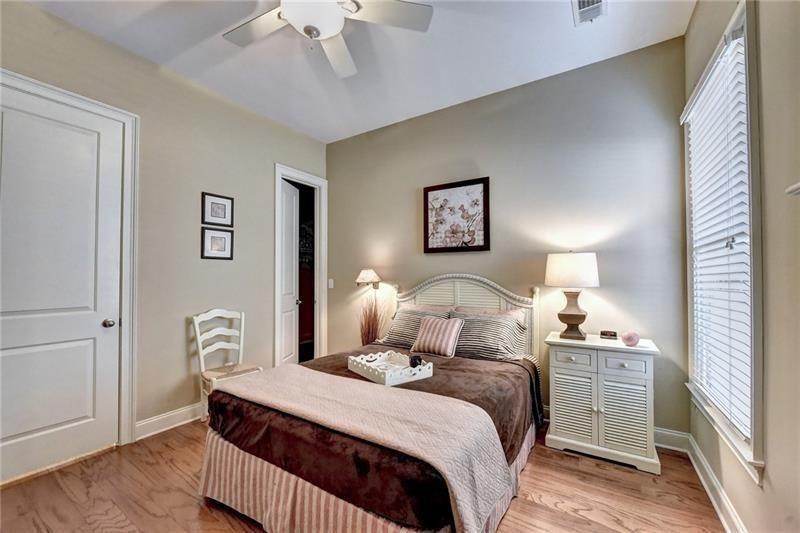 4865 Chase Lane Cumming, GA 30040 - Photo 42 of 70 a bedroom with a bed and a lamp with wooden floor