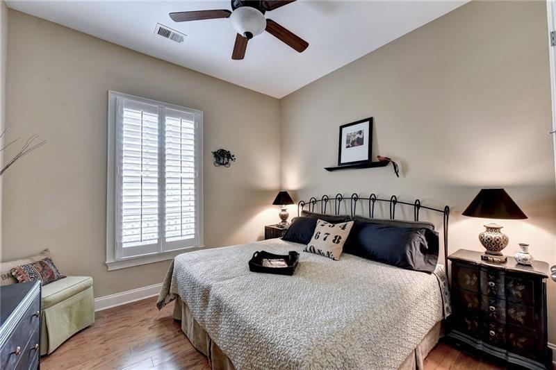 4865 Chase Lane Cumming, GA 30040 - Photo 46 of 70 a bedroom with a bed and wooden floor