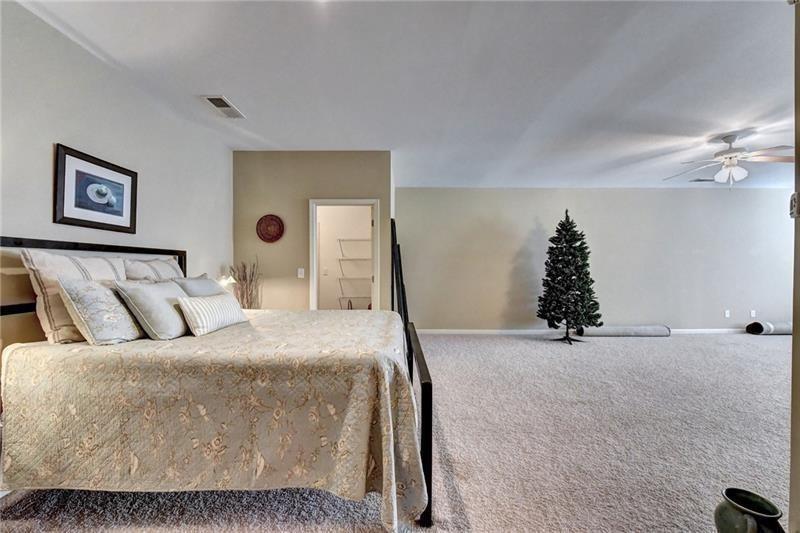 4865 Chase Lane Cumming, GA 30040 - Photo 48 of 70 a bed room with a bed and a couch