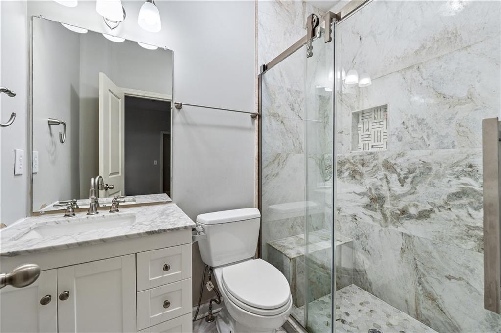 4865 Chase Lane Cumming, GA 30040 - Photo 50 of 70 a bathroom with a sink a toilet and shower