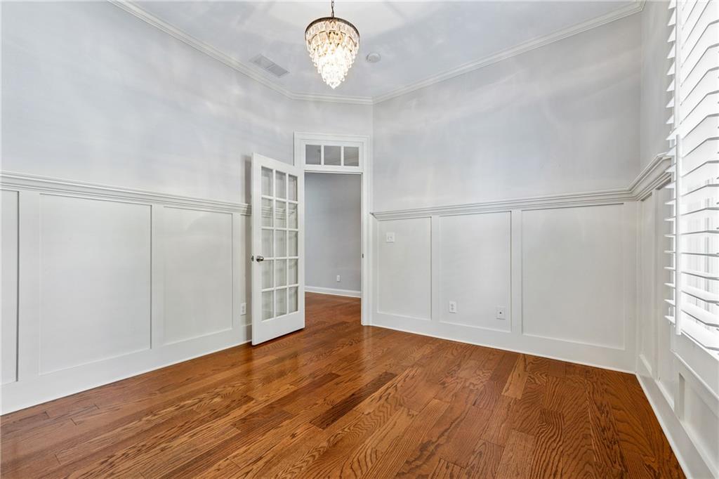 4865 Chase Lane Cumming, GA 30040 - Photo 9 of 70 an empty room with wooden floor and windows
