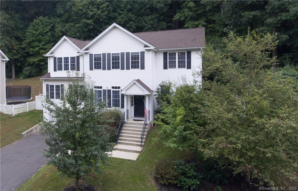 22 Apollo Road Bethel, CT 06801 - Photo 1 of 1 a front view of a house with a yard and green space