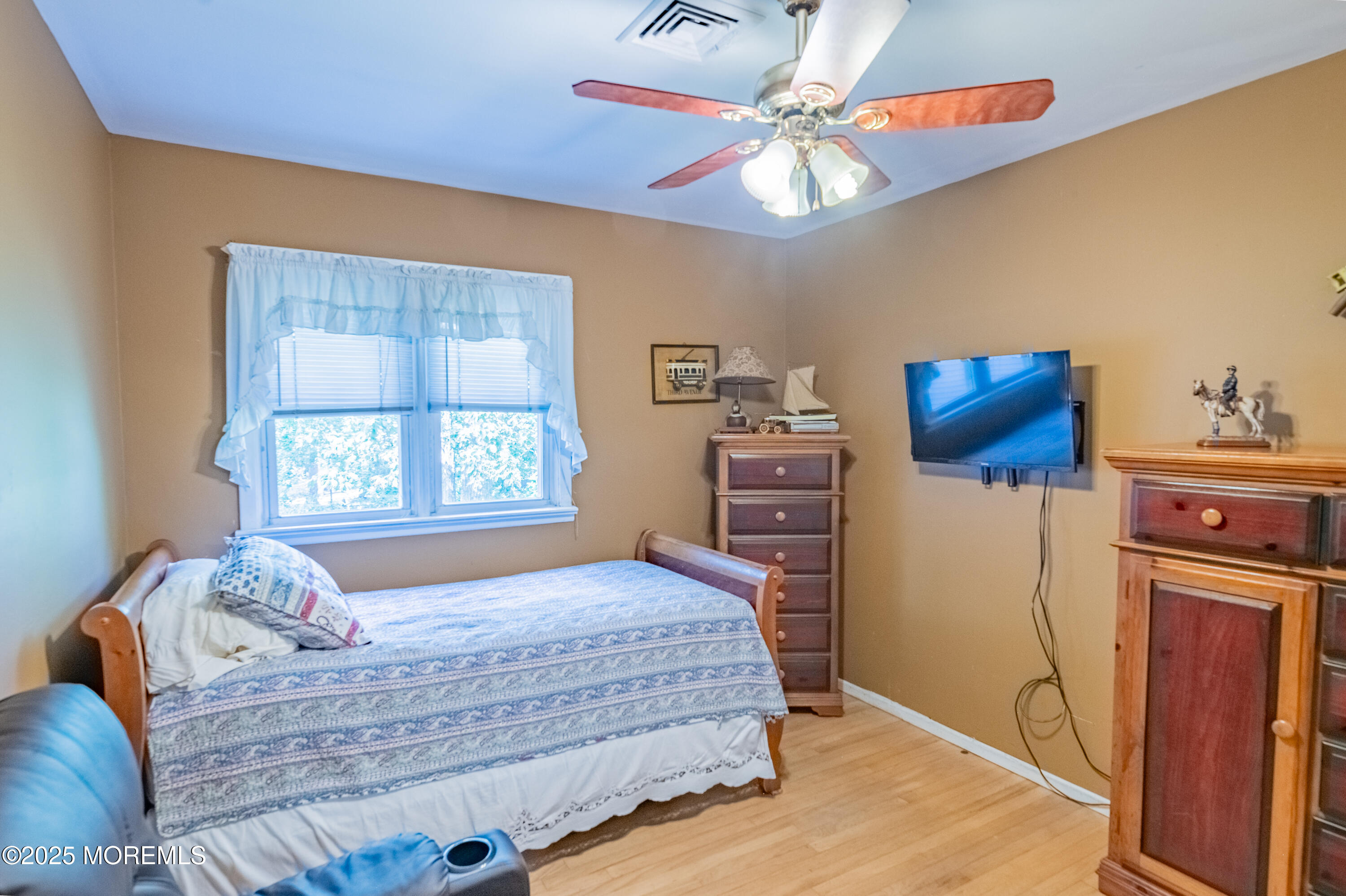 806 West Farms Road Howell, NJ 07731 - Photo 19 of 31 a bedroom with a bed and a flat tv screen on dresser