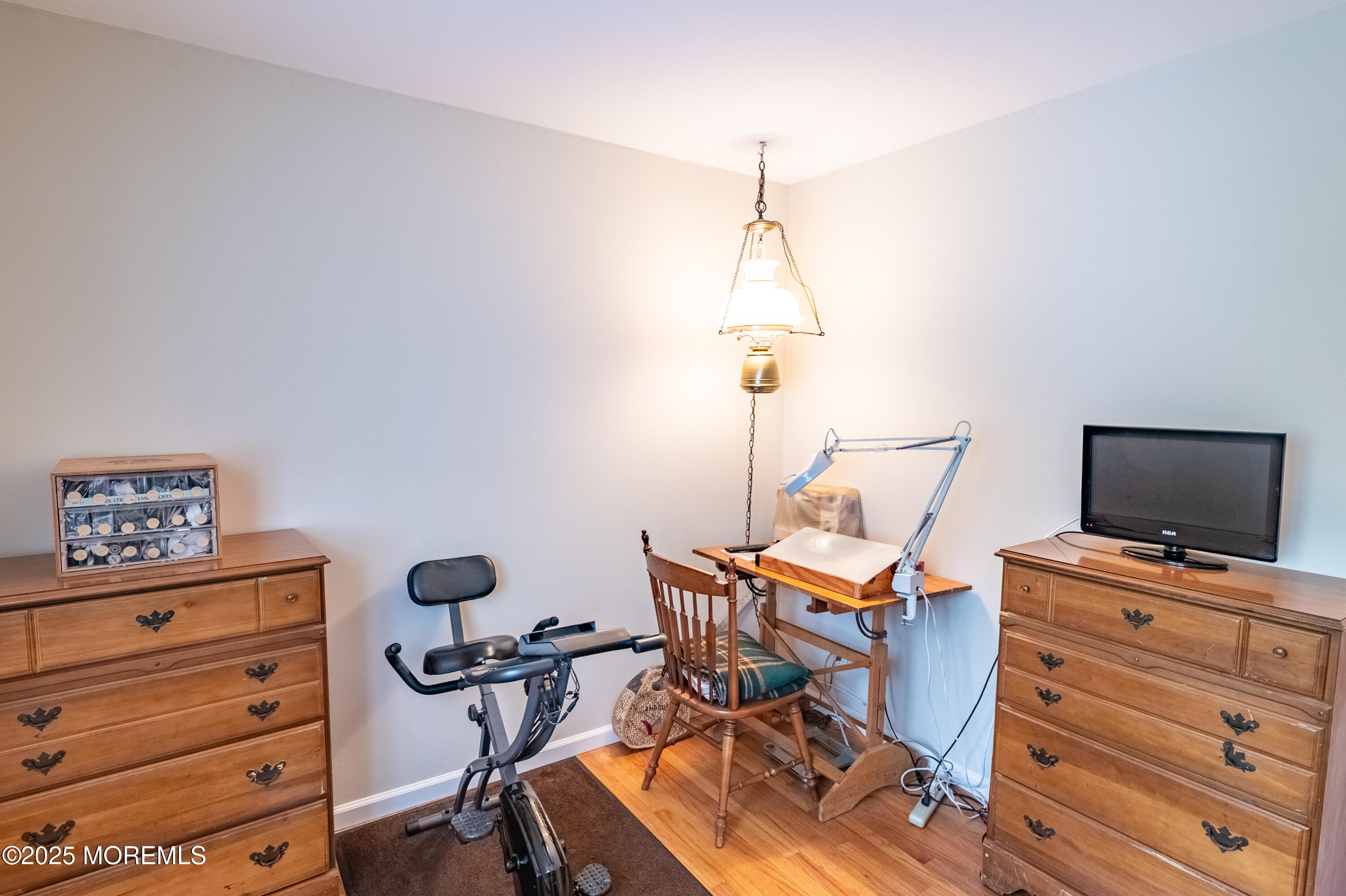 806 West Farms Road Howell, NJ 07731 - Photo 20 of 31 a room with gym equipment and wooden floor