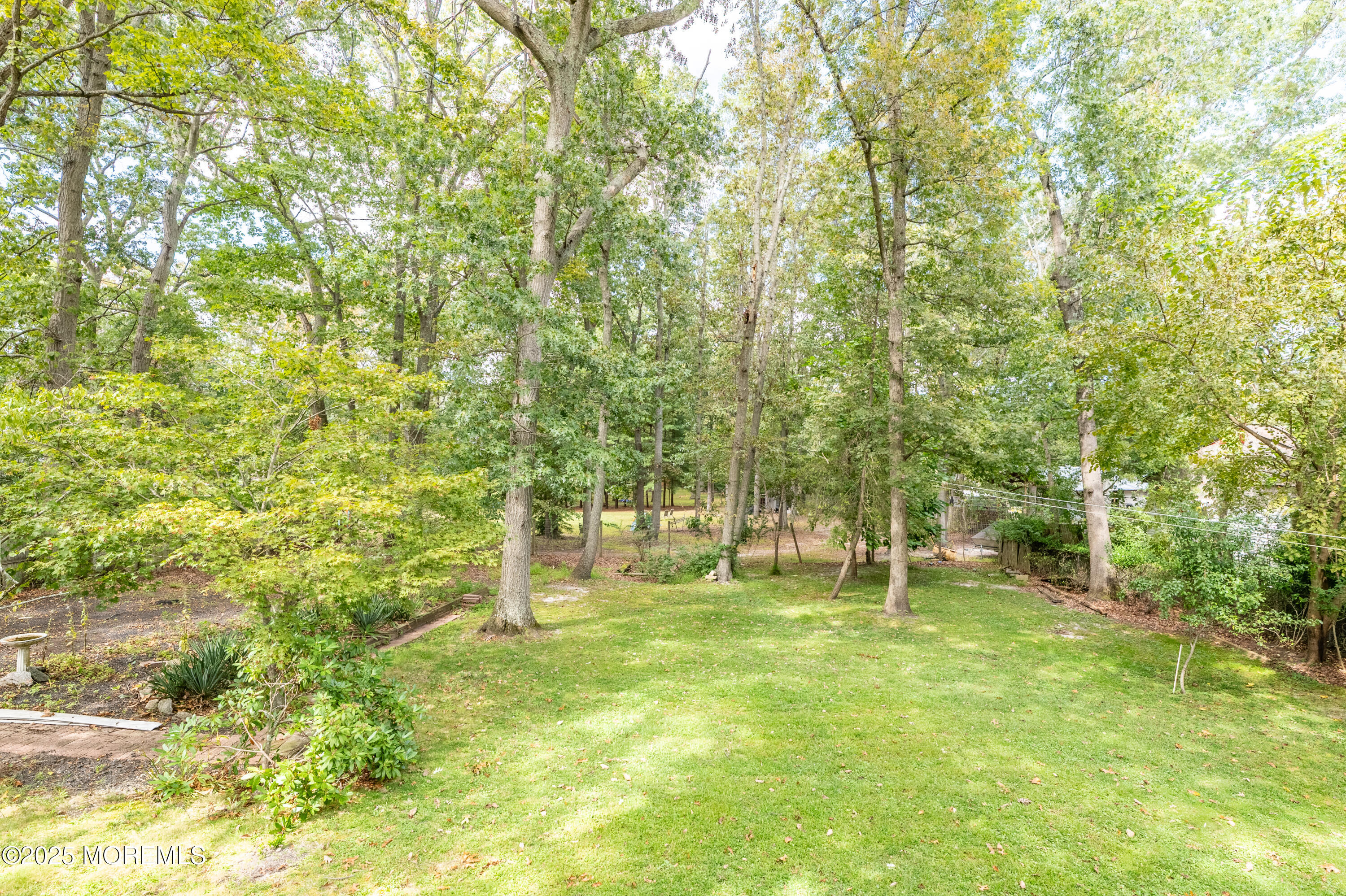 806 West Farms Road Howell, NJ 07731 - Photo 24 of 31 a backyard of a house with lots of green space and garden