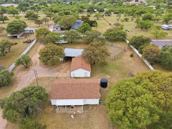 an aerial view of a house with garden space and street view