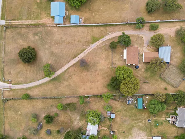 an aerial view of residential houses with outdoor space