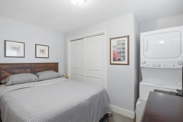 a bedroom with a bed and painting on the wall