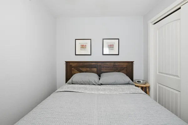 a view of a house with wooden stairs and a large tree