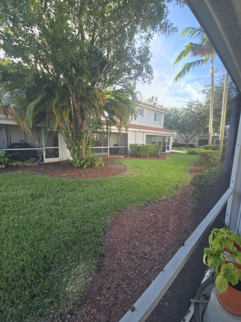6511 Sandy Bank Terrace Riviera Beach, FL 33407 - Photo 3 of 12 a view of a house with a yard