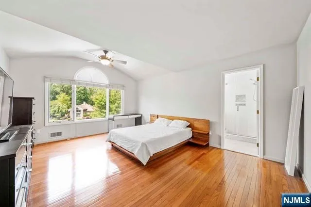 a bedroom with furniture and a large window
