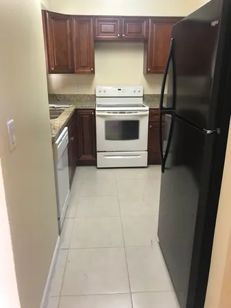 a kitchen with a stove top oven and sink
