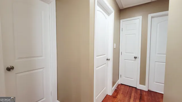 a view of a hallway with wooden floor