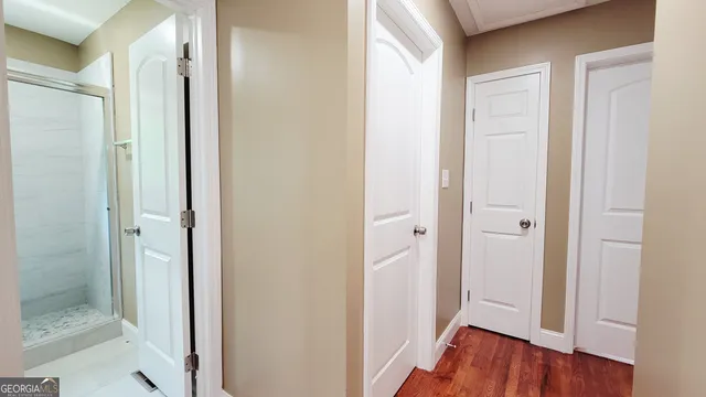 a view of a hallway with wooden floor