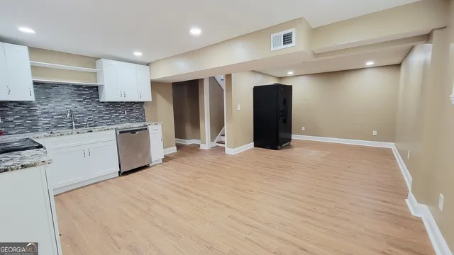 a large white kitchen with a sink