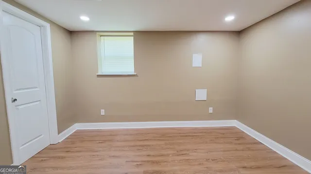 a view of an empty room with wooden floor