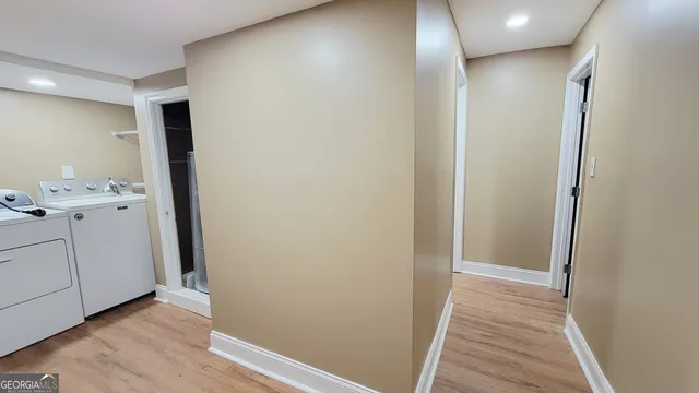 a view of hallway with wooden floor