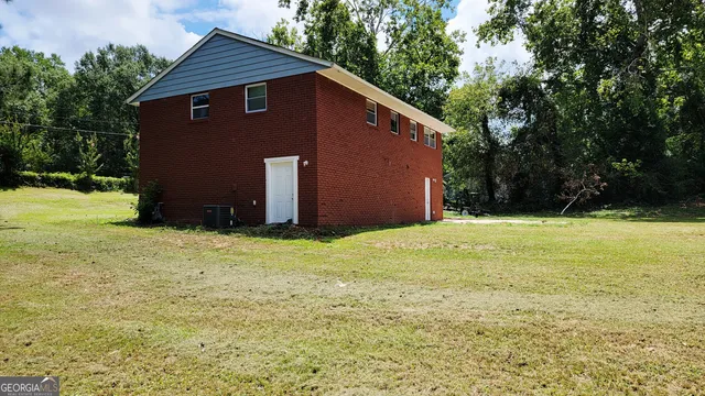a front view of house with yard and trees