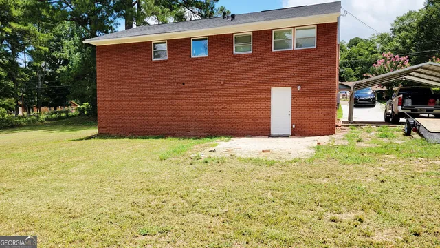 a backyard of a house with yard and outdoor seating