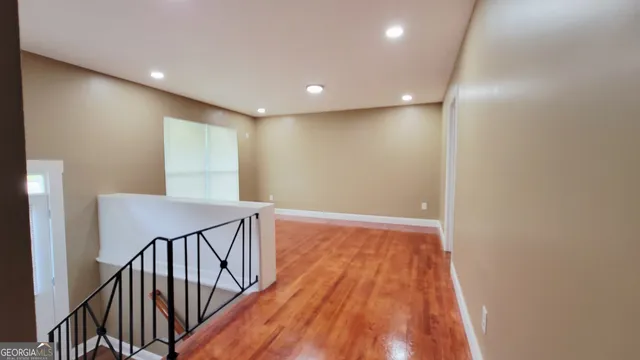 a view of hallway with wooden floor