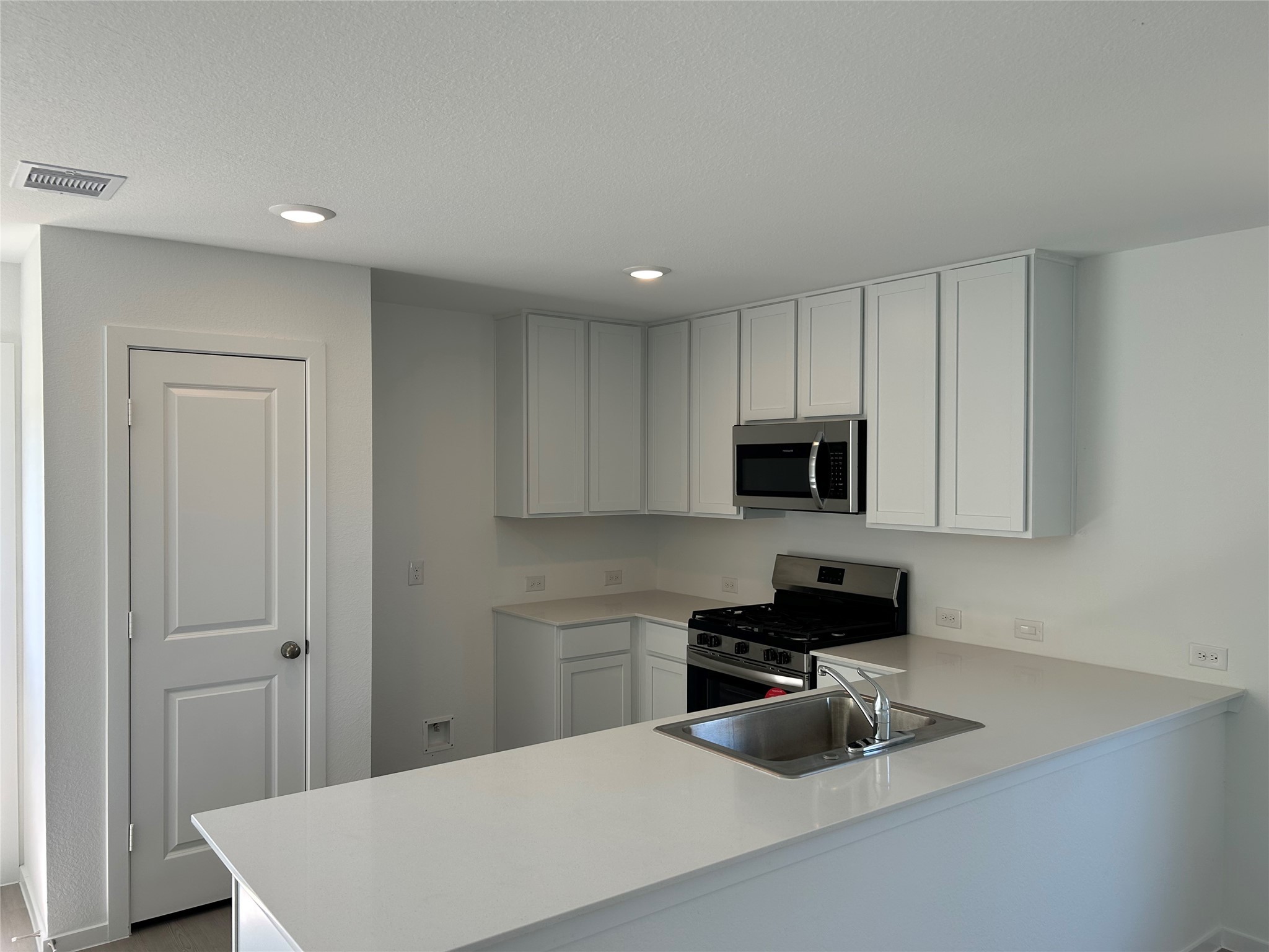 9018 Song Sparrow Way Baytown, TX 77521 - Photo 4 of 21 a kitchen with sink cabinets and stainless steel appliances