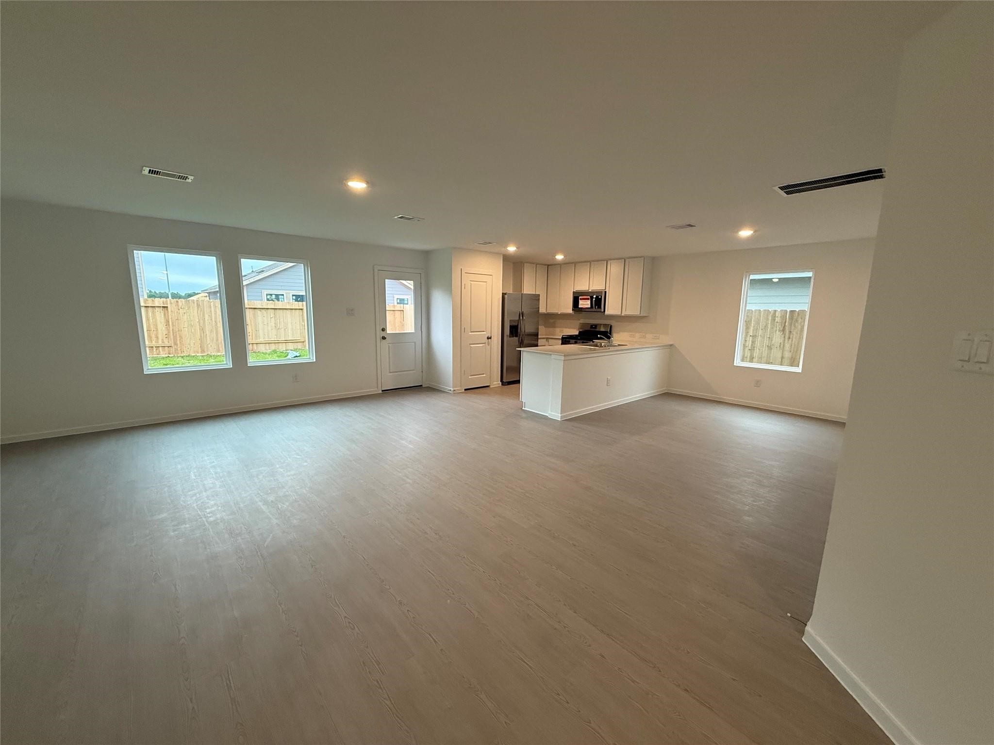 9018 Song Sparrow Way Baytown, TX 77521 - Photo 7 of 21 a view of a big room with windows and chandelier