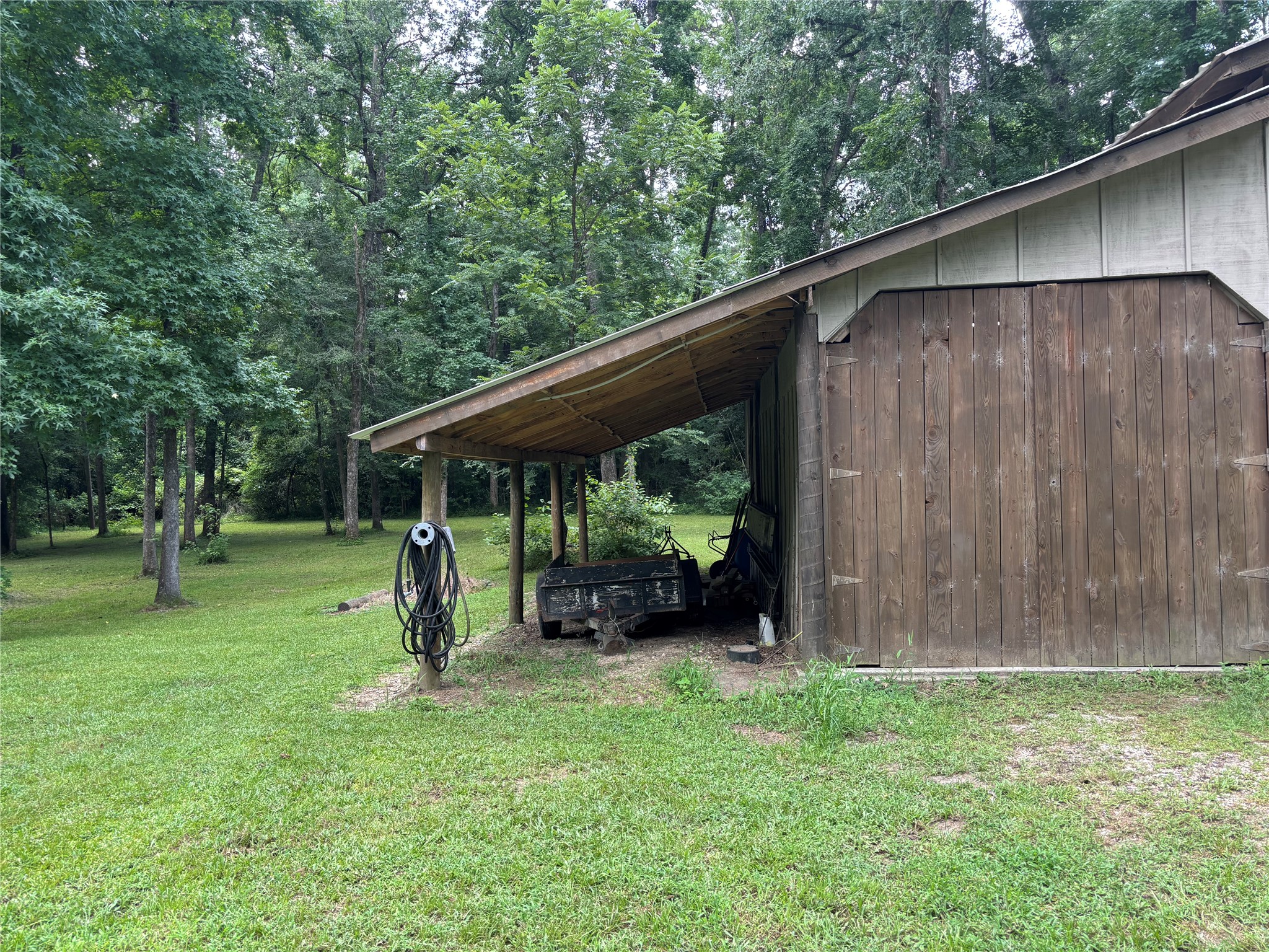 141 Walnut Loop Shepherd, TX 77371 - Photo 10 of 50 There is a side here to park a boat- or you can park it inside the barn as well-