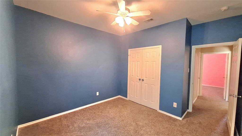 953 Hannah Way Dallas, TX 75253 - Photo 7 of 22 Carpeted room with blue walls, featuring a ceiling fan with light fixture
