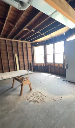 a bedroom with furniture and a window