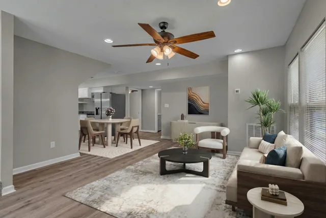 a living room with furniture and a wooden floor