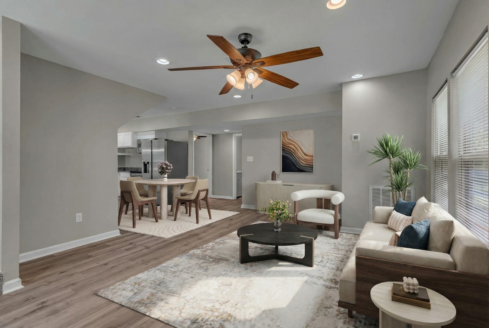 a living room with furniture and a wooden floor