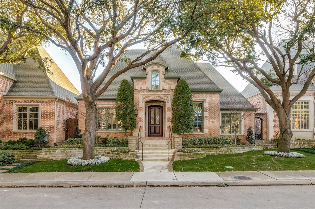 5620 Shubert Court Dallas, TX 75252 - Photo 1 of 32 a front view of a house with a garden and trees