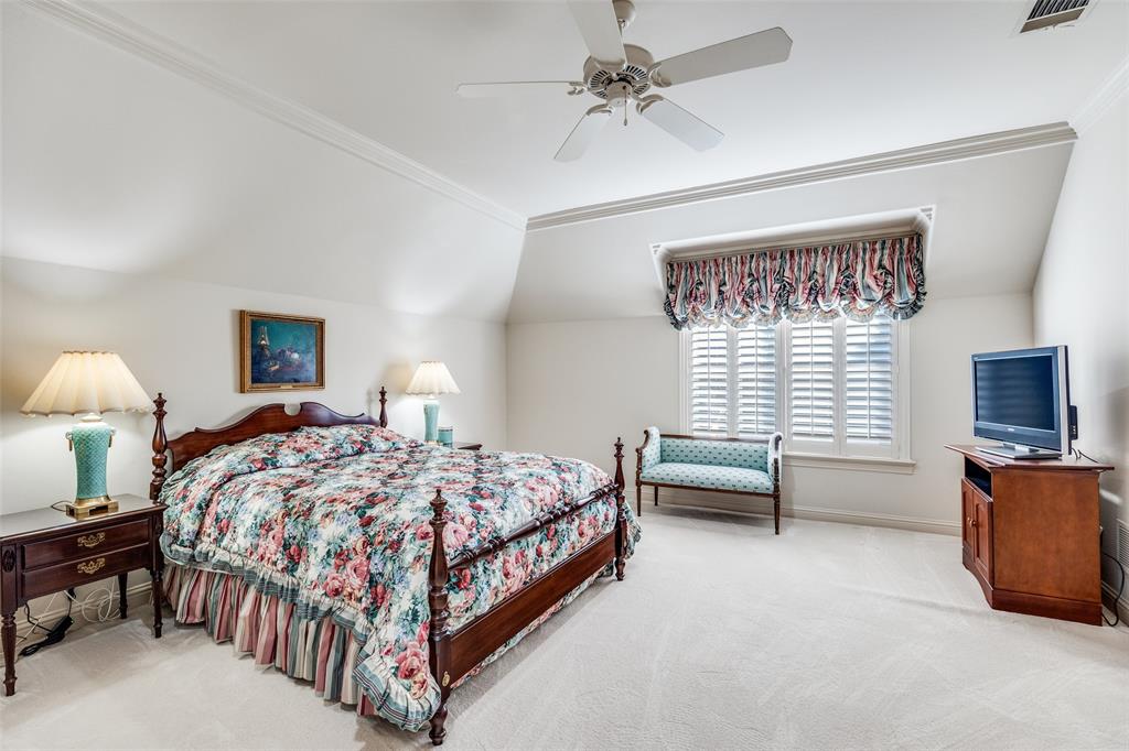5620 Shubert Court Dallas, TX 75252 - Photo 17 of 32 a bedroom with a bed and a chandelier
