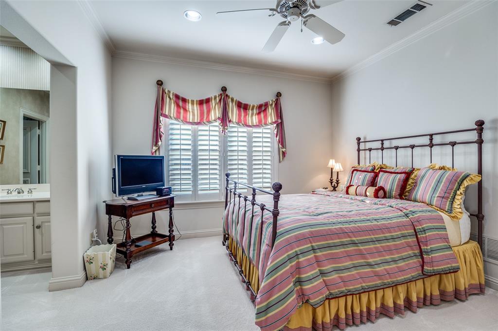 5620 Shubert Court Dallas, TX 75252 - Photo 18 of 32 a bedroom with a bed and a chandelier