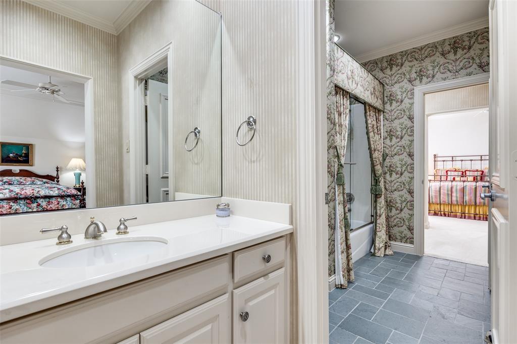 5620 Shubert Court Dallas, TX 75252 - Photo 19 of 32 a en suite bathroom with a granite countertop sink and a mirror