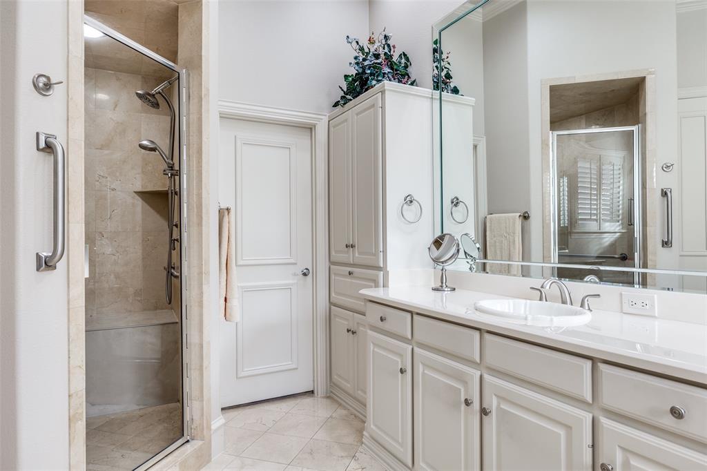 5620 Shubert Court Dallas, TX 75252 - Photo 23 of 32 a bathroom with a double vanity sink mirror and shower