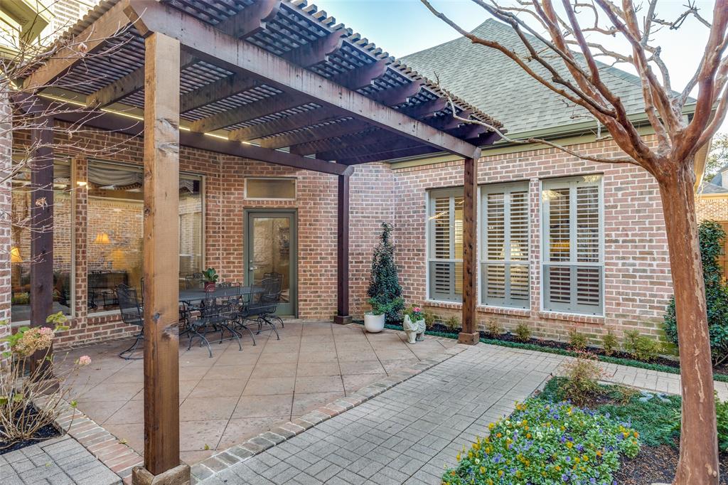 5620 Shubert Court Dallas, TX 75252 - Photo 26 of 32 a front view of a house with glass windows and plants