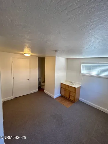a view of an empty room with a fireplace