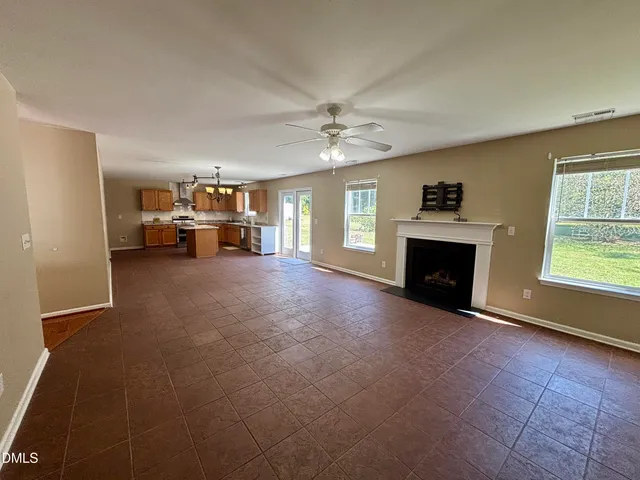 a view of livingroom with furniture fireplace and window