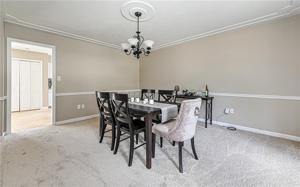 124 Fox Meadow Drive Wexford, PA 15090 - Photo 17 of 37 a view of a dining room with furniture and chandelier