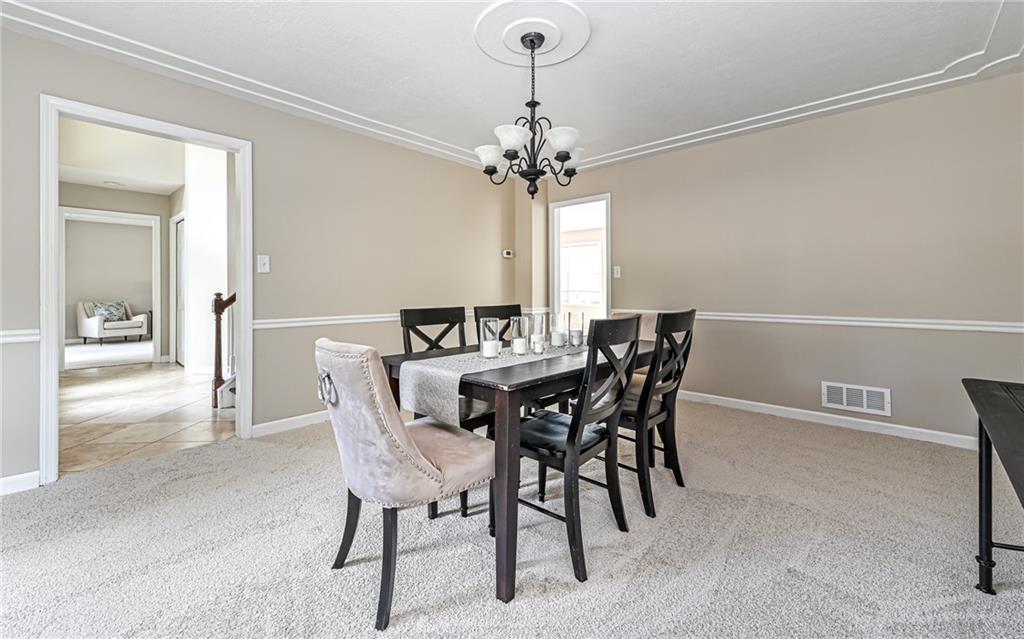 124 Fox Meadow Drive Wexford, PA 15090 - Photo 18 of 37 a view of a dining room with furniture and chandelier