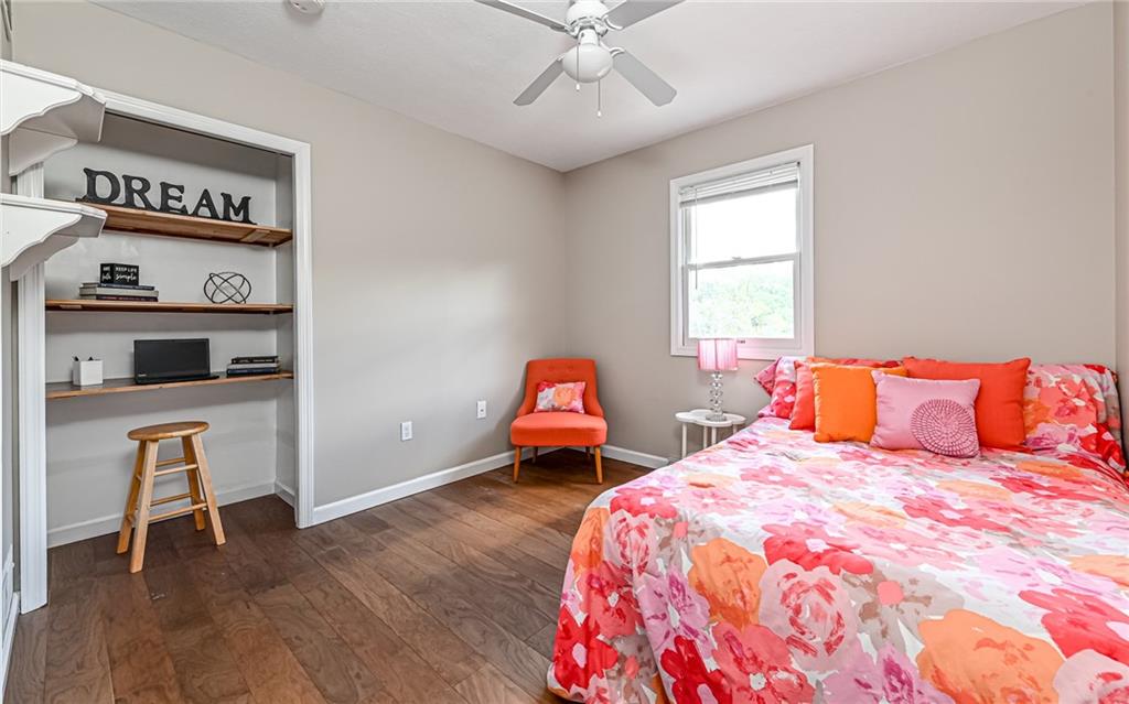 124 Fox Meadow Drive Wexford, PA 15090 - Photo 22 of 37 a bedroom with a bed and wooden floor