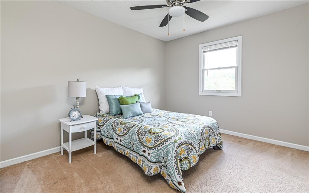 124 Fox Meadow Drive Wexford, PA 15090 - Photo 23 of 37 a bedroom with a bed and a chandelier