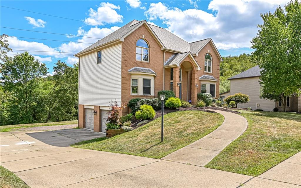 124 Fox Meadow Drive Wexford, PA 15090 - Photo 32 of 37 a front view of a house with a yard and potted plants