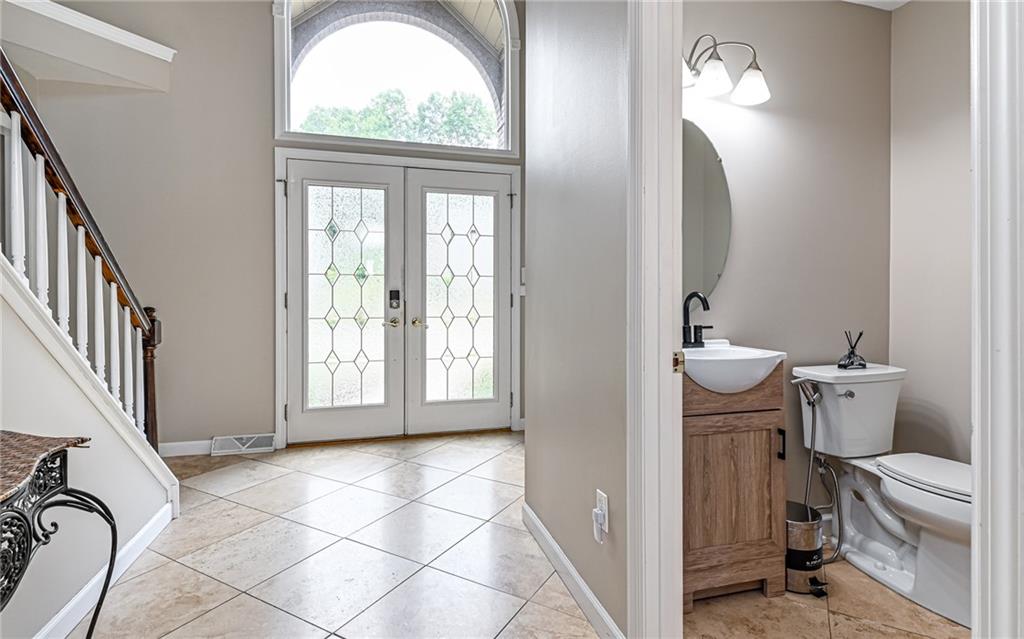 124 Fox Meadow Drive Wexford, PA 15090 - Photo 4 of 37 a view of a bathroom with bathtub windows and a chandelier