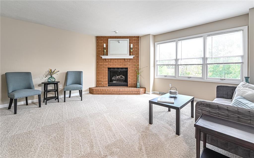 124 Fox Meadow Drive Wexford, PA 15090 - Photo 9 of 37 a living room with furniture and a fireplace